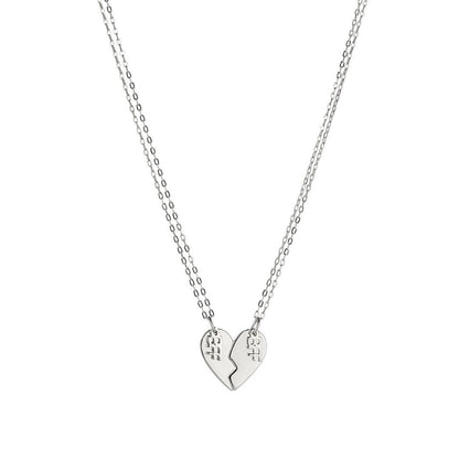 Product image of a pair of sterling silver best friend necklaces that when put together, make the shape of a heart. Each side of the heart has a charm attached with the word 'BFF'.